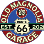 Old Magnolia Garage Route 66 logo featuring a magnolia flower, vintage highway sign, and "Established 2021" text in a retro red, white, and blue color scheme.